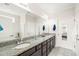 Bright bathroom featuring double vanity with granite countertop and tile floor at 104 Spindle Dr, Durham, NC 27703