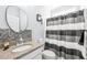 Bathroom showcasing vanity with granite countertop and black-and-white striped shower curtain at 104 Spindle Dr, Durham, NC 27703