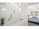 Walk-in shower with glass door showcasing safety bar and window at 104 Spindle Dr, Durham, NC 27703