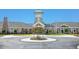 Community clubhouse with manicured landscaping, clock tower, and circular driveway at 104 Spindle Dr, Durham, NC 27703