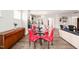 Bright dining area with a glass table, red chairs, and an open view of the kitchen and living spaces at 104 Spindle Dr, Durham, NC 27703