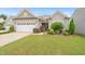 Charming single-Gathering home with a well-manicured lawn, attractive landscaping, and a two-car garage at 104 Spindle Dr, Durham, NC 27703
