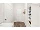 Inviting hallway featuring a white storage unit with wicker baskets and hardwood flooring at 104 Spindle Dr, Durham, NC 27703