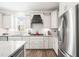 Well-lit kitchen with white cabinets, stainless steel appliances, granite countertops, and a subway tile backsplash at 104 Spindle Dr, Durham, NC 27703