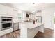Modern kitchen featuring white cabinets, stainless steel appliances, granite countertops, and a center island at 104 Spindle Dr, Durham, NC 27703