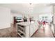 Spacious kitchen featuring a granite island with views of the living room and dining area at 104 Spindle Dr, Durham, NC 27703