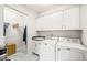 Laundry room with washer, dryer and white cabinets at 104 Spindle Dr, Durham, NC 27703