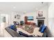 Spacious living room features hardwood floors, a fireplace, large TV and comfortable seating arrangement at 104 Spindle Dr, Durham, NC 27703