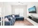 Cozy living room with a blue sectional sofa and wall-mounted TV at 104 Spindle Dr, Durham, NC 27703