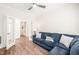 Comfortable living room featuring a blue sectional sofa, hardwood floor and a double doorway at 104 Spindle Dr, Durham, NC 27703