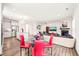 Bright dining area with a glass table, red chairs, and an open view of the kitchen and living spaces at 104 Spindle Dr, Durham, NC 27703