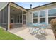 Rear patio with screened-in porch offers cozy outdoor seating at 104 Spindle Dr, Durham, NC 27703
