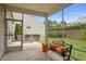 Screened-in porch offering outdoor seating with a view of landscaped backyard at 104 Spindle Dr, Durham, NC 27703