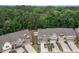 Aerial view of townhomes with private driveways, landscaping, and surrounding green trees at 1048 Flagler St, Durham, NC 27713