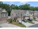 An aerial view of the townhome community with manicured lawns, driveways, and lush trees at 1048 Flagler St, Durham, NC 27713
