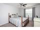 Comfortable bedroom features a wooden bed frame, soft patterned bedding, and a ceiling fan at 1048 Flagler St, Durham, NC 27713