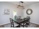 Dining room features a dark wood table and chairs, modern lighting, and access to the outdoors at 1048 Flagler St, Durham, NC 27713