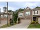Charming townhome featuring a two-car garage, stone accents, and low-maintenance landscaping at 1048 Flagler St, Durham, NC 27713