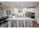 Modern kitchen with a large island, stainless steel appliances, pendant lighting, and breakfast bar at 1048 Flagler St, Durham, NC 27713