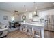 Well-lit kitchen with a center island, stainless steel appliances, and open dining area at 1048 Flagler St, Durham, NC 27713