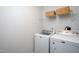 Convenient laundry room features a washer, dryer, and wire shelving for storage at 1048 Flagler St, Durham, NC 27713