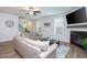 Bright living room with hardwood floors, a fireplace, a comfortable sofa, and modern decor at 1048 Flagler St, Durham, NC 27713