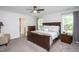 Inviting main bedroom with dark wood furniture, a comfortable bed, ceiling fan, and natural light at 1048 Flagler St, Durham, NC 27713
