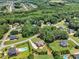 Lush green neighborhood featuring expansive homes, mature trees, swimming pools, and well-manicured lawns at 105 Somerley Dr, Garner, NC 27529