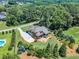 Expansive aerial view of the property showcasing the home, lush landscaping, and a refreshing swimming pool at 105 Somerley Dr, Garner, NC 27529