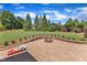 Lush backyard featuring a stone fire pit and lawn game at 105 Somerley Dr, Garner, NC 27529