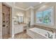 Beautiful bathroom featuring a soaking tub, tiled shower, and granite countertops at 105 Somerley Dr, Garner, NC 27529