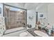 Features a tub and shower combo with glass doors, tile surround, and granite countertops at 105 Somerley Dr, Garner, NC 27529