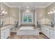 Bright bathroom featuring a large soaking tub, dual sinks, and tile flooring at 105 Somerley Dr, Garner, NC 27529
