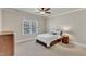 Cozy bedroom featuring a ceiling fan, a window, and carpet flooring at 105 Somerley Dr, Garner, NC 27529