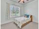 This bedroom features a ceiling fan, carpet, and a window with backyard views at 105 Somerley Dr, Garner, NC 27529