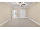 Neutral bedroom featuring a ceiling fan, carpet, and closet with double doors at 105 Somerley Dr, Garner, NC 27529
