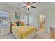 Well-lit bedroom with ceiling fan, bright windows, and ensuite bathroom at 105 Somerley Dr, Garner, NC 27529