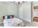 This bedroom features a ceiling fan, carpet, and a door to the hallway at 105 Somerley Dr, Garner, NC 27529