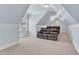 Upstairs bonus room with angled ceiling, window, and theater seating at 105 Somerley Dr, Garner, NC 27529