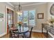 Cozy breakfast nook with hardwood floors, a round table, and large window with backyard views at 105 Somerley Dr, Garner, NC 27529
