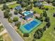 Aerial view of community amenities: pool, clubhouse, tennis court, and parking at 105 Somerley Dr, Garner, NC 27529