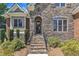 Stone and brick home exterior featuring a charming front entrance with a wreath at 105 Somerley Dr, Garner, NC 27529