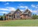 Attractive stone and brick home boasts well-maintained landscaping and a vibrant green lawn at 105 Somerley Dr, Garner, NC 27529