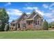 Stunning stone and brick home with professionally landscaped yard and lush, green lawn at 105 Somerley Dr, Garner, NC 27529