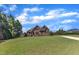 Charming two-story home featuring stone and brick architecture, enhanced by a lush, green lawn at 105 Somerley Dr, Garner, NC 27529