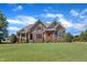 Beautiful two-story stone and brick home with mature landscaping and a manicured lawn at 105 Somerley Dr, Garner, NC 27529