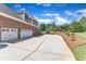 Large three-car garage with a spacious driveway and beautifully landscaped backyard at 105 Somerley Dr, Garner, NC 27529