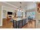 Open kitchen with island seating, stainless appliances, and granite counters adjoins a sunny breakfast nook and inviting living room at 105 Somerley Dr, Garner, NC 27529