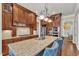 Features a large island with granite countertops, wood cabinets, stainless steel appliances, and pendant lighting at 105 Somerley Dr, Garner, NC 27529