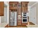 The kitchen features stainless steel appliances, wood cabinets, granite countertops, and hardwood floors at 105 Somerley Dr, Garner, NC 27529